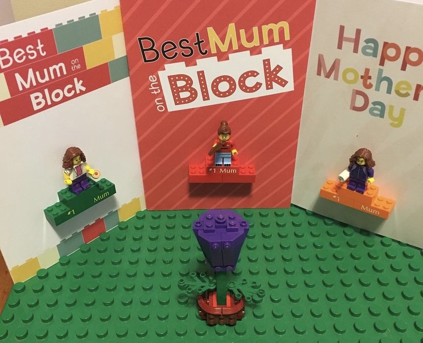 Image of three separate Mothers' Day cards, each with LEGO Mum figures, with a single purple LEGO tulip in front